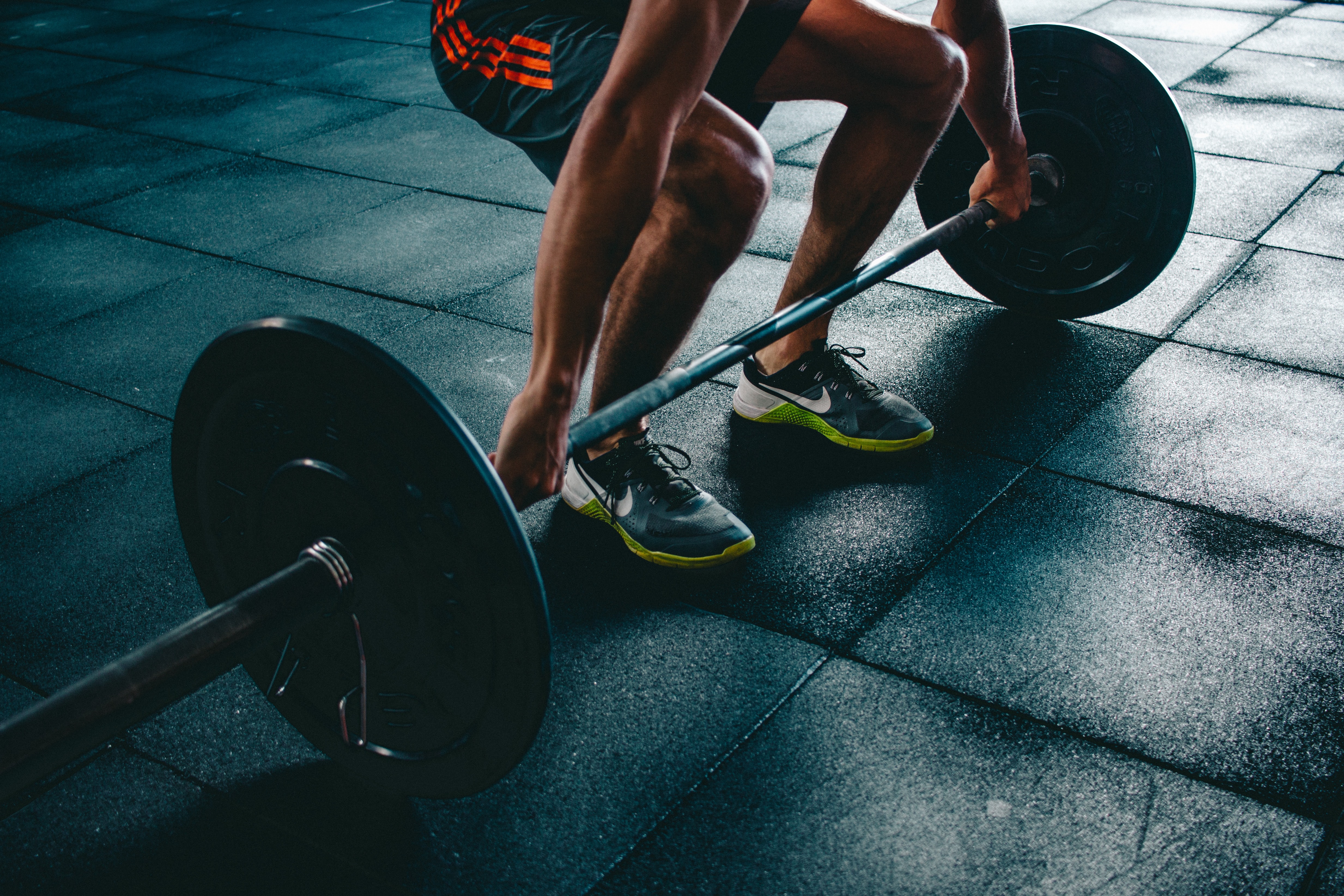 person with barbell in hands